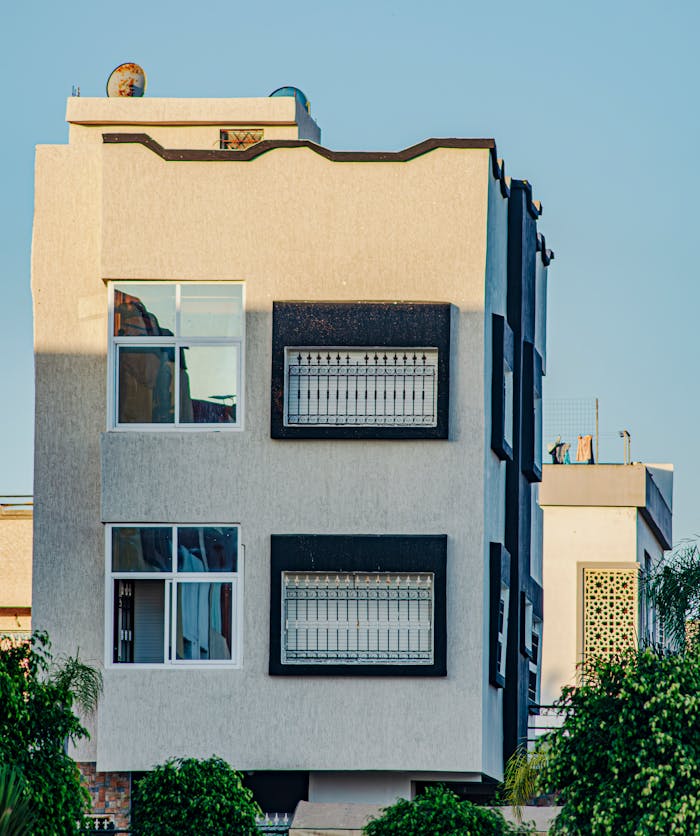 our-experience Contemporary urban building exterior with large windows and geometric design.