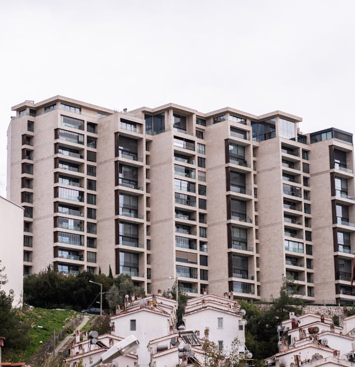 High-rise residential building in Izmir, Turkey, showcasing contemporary architecture against a cloudy sky.